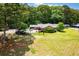 Beautiful home with a private backyard oasis, featuring a pool and lush landscaping at 1050 Denton Rd, Douglasville, GA 30134
