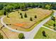A vast, expansive, aerial view of the property, featuring mature trees, landscaping, and a long, private driveway at 1050 Denton Rd, Douglasville, GA 30134