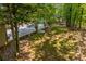 Outdoor patio area surrounded by mature trees and lush landscaping, offering a peaceful retreat at 1050 Denton Rd, Douglasville, GA 30134