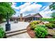 Enjoy outdoor living with a large patio and a stone fireplace in this meticulously landscaped backyard at 1050 Denton Rd, Douglasville, GA 30134