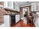 Stylish bar area with custom cabinets, granite countertops, wine cooler, and brick backsplash at 1050 Denton Rd, Douglasville, GA 30134