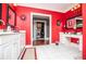 Bright, red bathroom featuring tile floors, dual sinks, and a makeup vanity at 1050 Denton Rd, Douglasville, GA 30134