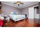 Bedroom with hardwood floors, ceiling fan, closet doors and neutral toned walls at 1050 Denton Rd, Douglasville, GA 30134