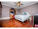 Bedroom with hardwood floors, ceiling fan, closet doors and neutral toned walls at 1050 Denton Rd, Douglasville, GA 30134
