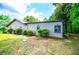 Side exterior view of home showing manicured landscaping, bushes, and well-maintained yard at 1050 Denton Rd, Douglasville, GA 30134