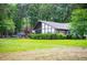 Stunning exterior elevation showcasing modern architecture, large windows, and meticulously maintained landscaping at 1050 Denton Rd, Douglasville, GA 30134