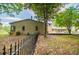 Side view of home featuring a large patio, lush landscaping, and privacy fencing at 1050 Denton Rd, Douglasville, GA 30134