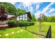 Home with lots of windows, a well-manicured lawn, mature trees, and decorative fence at 1050 Denton Rd, Douglasville, GA 30134