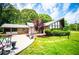 Unique architectural design with a wall of windows and a well-manicured front yard and patio at 1050 Denton Rd, Douglasville, GA 30134