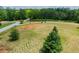A wide, grassy area leads to a road with trees around the property at 1050 Denton Rd, Douglasville, GA 30134