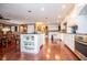 Open-concept kitchen featuring a center island, stainless steel appliances, and hardwood floors at 1050 Denton Rd, Douglasville, GA 30134