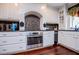 Beautiful kitchen featuring stainless steel appliances, custom cabinets, and decorative backsplash at 1050 Denton Rd, Douglasville, GA 30134