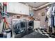 Convenient laundry room with checkerboard floor, washer, dryer, cabinets, and decor at 1050 Denton Rd, Douglasville, GA 30134
