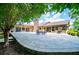 A backyard featuring a large patio and stone fireplace, perfect for outdoor entertainment and relaxation at 1050 Denton Rd, Douglasville, GA 30134