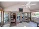Relaxing screened-in porch features ceiling fan, multiple doorways, and views at 1050 Denton Rd, Douglasville, GA 30134