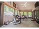 Comfortable screened-in porch with wicker furniture, ceiling fan, and outdoor views at 1050 Denton Rd, Douglasville, GA 30134