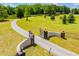 A long winding driveway leads to a gated property with a well-manicured lawn and mature trees at 1050 Denton Rd, Douglasville, GA 30134