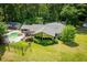 An aerial view displays a home with a pool, patio, and fenced yard at 1050 Denton Rd, Douglasville, GA 30134
