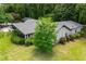 Rear exterior of a house with large windows, a well-kept lawn, and lush landscaping at 1050 Denton Rd, Douglasville, GA 30134