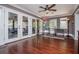 Sun room with multiple french doors, hardwood floors, and a ceiling fan at 1050 Denton Rd, Douglasville, GA 30134