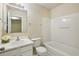 Bathroom with a single sink vanity, toilet, and shower-tub combo with white ceramic tile at 2159 Meadow Peak Rd, Duluth, GA 30097