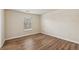 Inviting bedroom featuring hardwood floors, neutral paint, and a large window at 2159 Meadow Peak Rd, Duluth, GA 30097