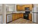 Well-equipped kitchen with stainless steel appliances, granite countertops, and wooden cabinetry at 2159 Meadow Peak Rd, Duluth, GA 30097