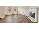 Spacious living room with a fireplace, large windows offering natural light, and hardwood flooring at 2159 Meadow Peak Rd, Duluth, GA 30097