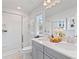 Elegant bathroom featuring a dual sink vanity, glass-enclosed shower, and modern fixtures for a luxurious experience at 3136 Washburn Se St, Atlanta, GA 30354
