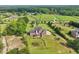 Expansive estate featuring a brick home with an outdoor patio, a large lawn, and mature trees at 3480 Indian Shoals Rd, Dacula, GA 30019