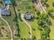 Overhead view of a property with a large house, extensive lawn, and a winding driveway at 3480 Indian Shoals Rd, Dacula, GA 30019