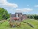 Expansive aerial view of the property, highlighting the lush backyard, pergola, and well-manicured lawn at 3480 Indian Shoals Rd, Dacula, GA 30019