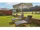 Backyard with lounge chairs, patio, and well-maintained lawn with lush landscaping at 3480 Indian Shoals Rd, Dacula, GA 30019