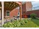 Inviting backyard patio with seating, outdoor bar, and beautifully landscaped garden area at 3480 Indian Shoals Rd, Dacula, GA 30019