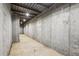 View of the unfinished basement, featuring concrete walls, floor, and exposed utilities at 3480 Indian Shoals Rd, Dacula, GA 30019