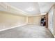 Spacious basement area with gray carpet, a decorative trey ceiling, and neutral walls at 3480 Indian Shoals Rd, Dacula, GA 30019