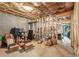 Unfinished basement storage area with exposed framing, insulation, and various stored items at 3480 Indian Shoals Rd, Dacula, GA 30019