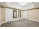 Finished basement area with soft carpet, neutral walls, and two framed mirrors at 3480 Indian Shoals Rd, Dacula, GA 30019