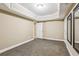 Finished basement area with soft carpet, neutral walls, and two framed mirrors at 3480 Indian Shoals Rd, Dacula, GA 30019