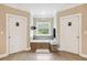 Bathroom with a soaking tub between and closets, and a window with a view at 3480 Indian Shoals Rd, Dacula, GA 30019