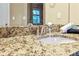 Bathroom granite countertop with a white sink and a brushed nickel faucet at 3480 Indian Shoals Rd, Dacula, GA 30019