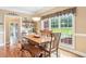Inviting dining area bathed in natural light from large windows overlooking the yard at 3480 Indian Shoals Rd, Dacula, GA 30019