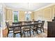 Well-lit dining area boasts an expansive table set beneath an elegant chandelier at 3480 Indian Shoals Rd, Dacula, GA 30019