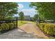 Long driveway leading to a charming home with meticulously maintained landscaping and inviting curb appeal at 3480 Indian Shoals Rd, Dacula, GA 30019