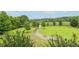 Long driveway leading up to the property through a verdant, tree-lined landscape at 3480 Indian Shoals Rd, Dacula, GA 30019