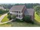Impressive brick home with double-decker balconies, manicured landscaping, and a welcoming driveway at 3480 Indian Shoals Rd, Dacula, GA 30019