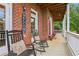 Charming front porch with rocking chairs, brick accents, and a welcoming atmosphere at 3480 Indian Shoals Rd, Dacula, GA 30019