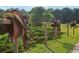 Horse saddles sit on a rustic fence row, highlighting the property's equestrian lifestyle at 3480 Indian Shoals Rd, Dacula, GA 30019