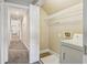 Convenient laundry room has white shelving, tile floor, and a washer hookup at 3480 Indian Shoals Rd, Dacula, GA 30019