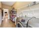 Well-equipped laundry room boasts storage shelves, a sink, and modern Samsung washer and dryer at 3480 Indian Shoals Rd, Dacula, GA 30019